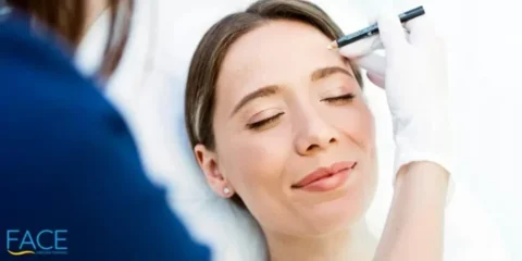 Young_woman_with_correction_dots_on_the_face_in_an_examination_room