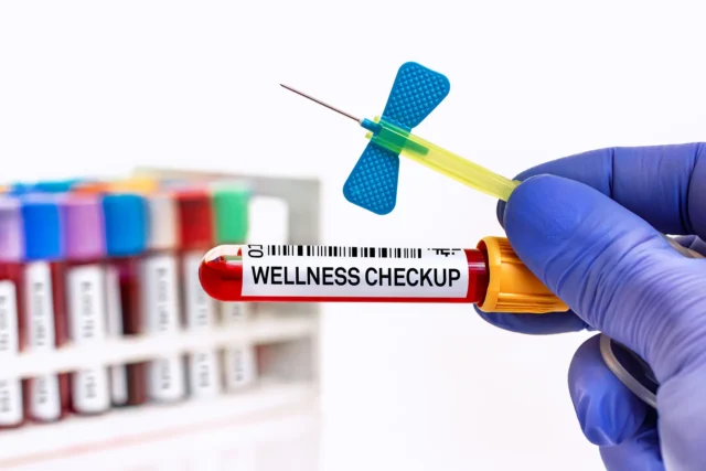 medical provider holding a butterfly needle and a test tube