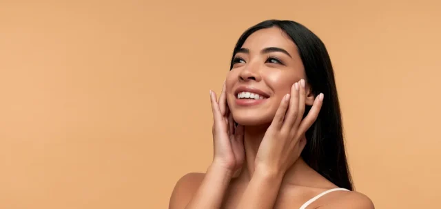 a woman touches her face after using pdrn essence