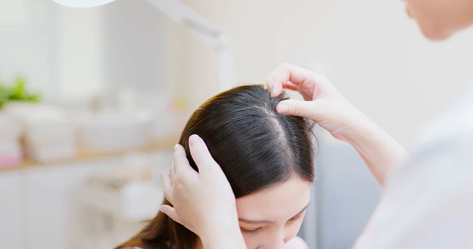 a provider inspects the hair anatomy of the patient before exosomes procedure